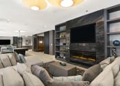 Thumbnail 20 of 28 - a living room with a large couch and a fireplace